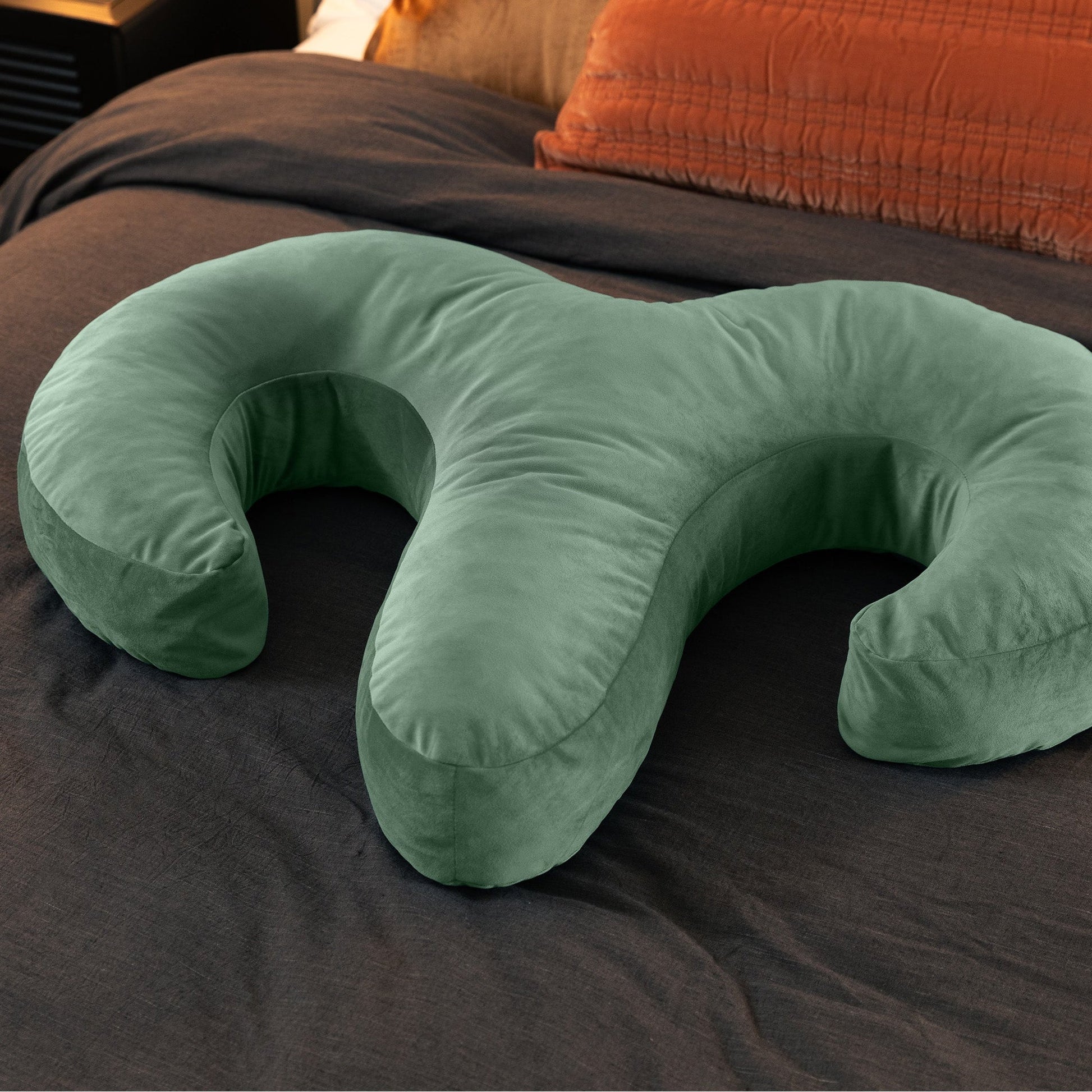 Sage Arie Duo Couples Pillow by Liberator laying on a bed,