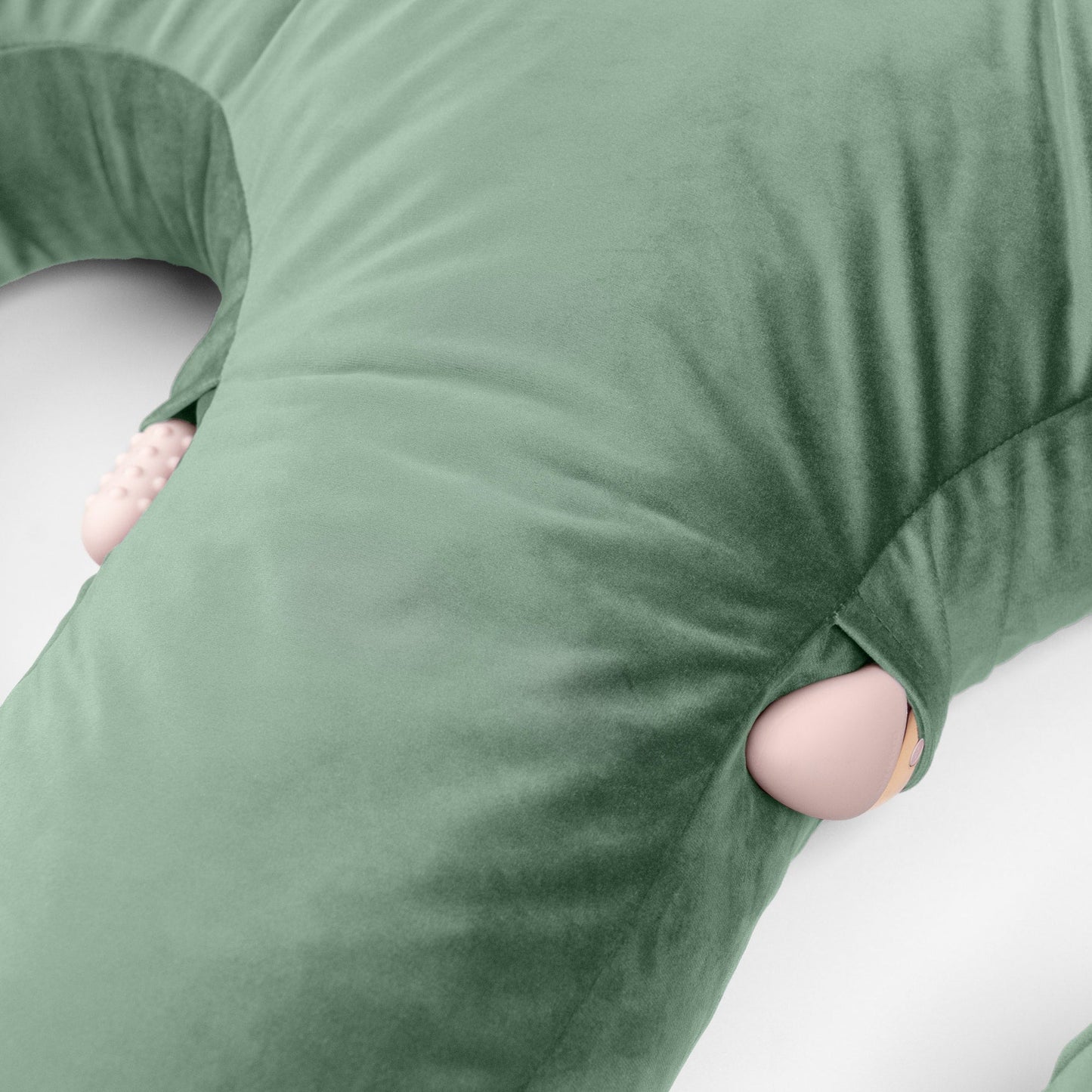 The pockegs of the Sage Arie Duo Couples Pillow by Liberator showing toys in the pockets against white background.