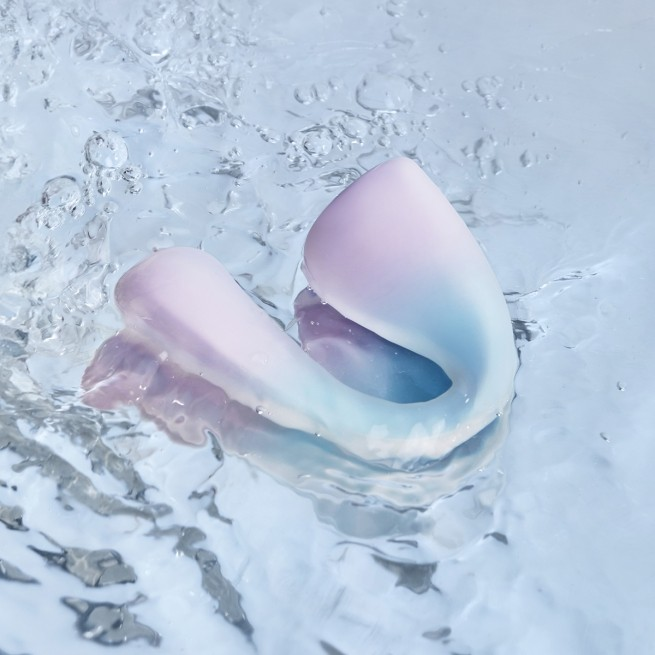 A pink C-Tail G-Spot Vibrator, Bedroom Toy by Liberator in water.