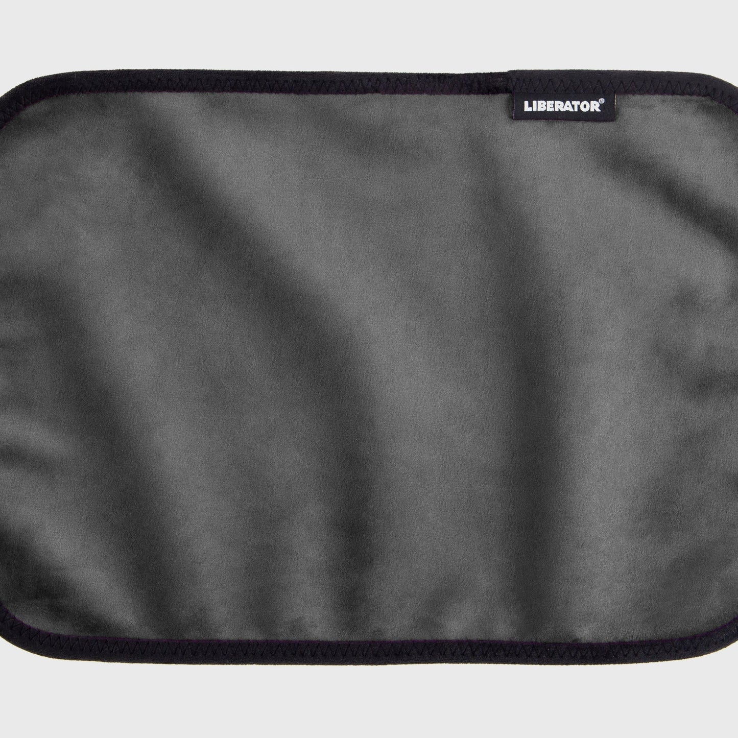 A grey Fascinator Splashproof Throws, Bedroom Furniture by Liberator unrolled up against a white background.