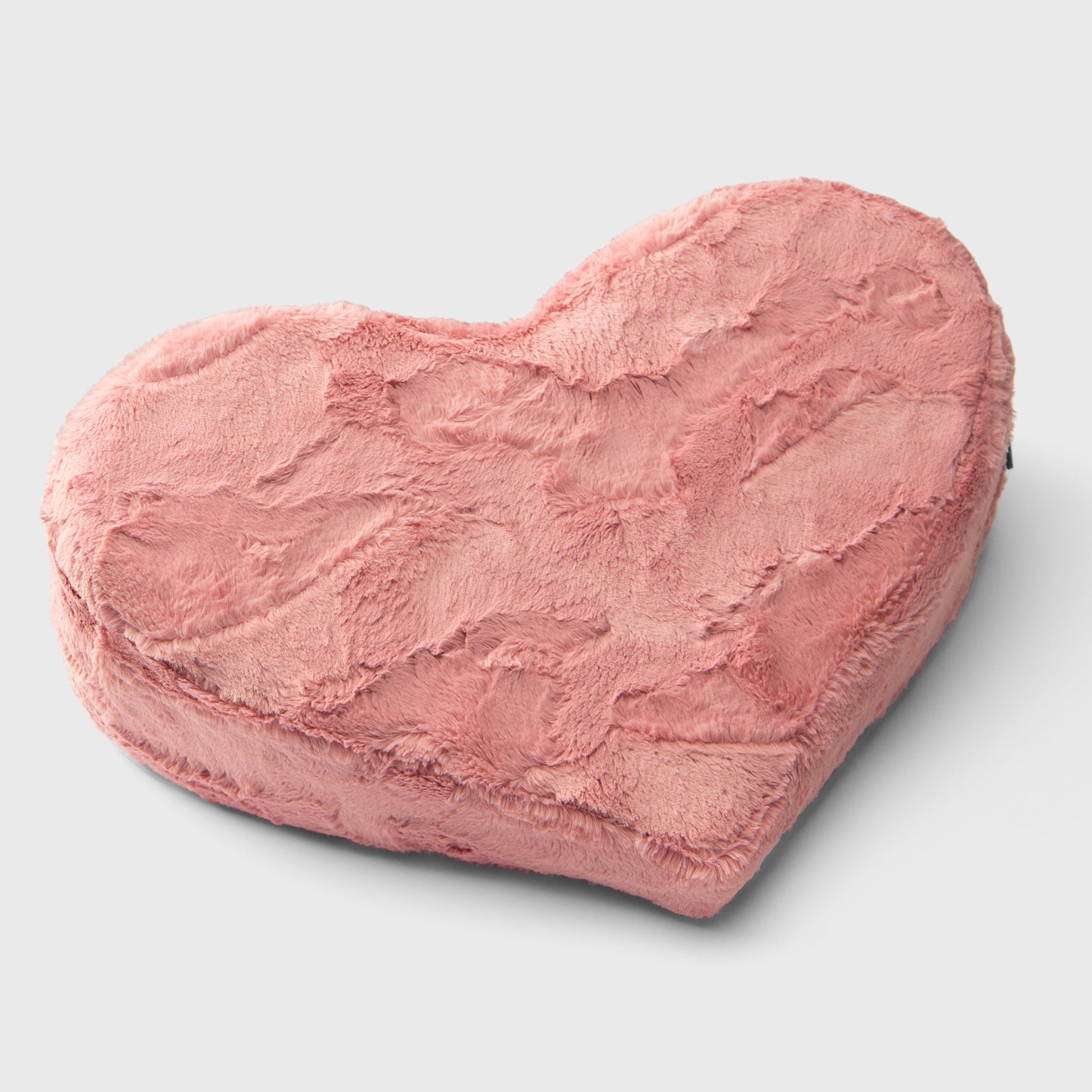 A faux fur pink Heart Wedge, Bedroom Furniture by Liberator against a white background.