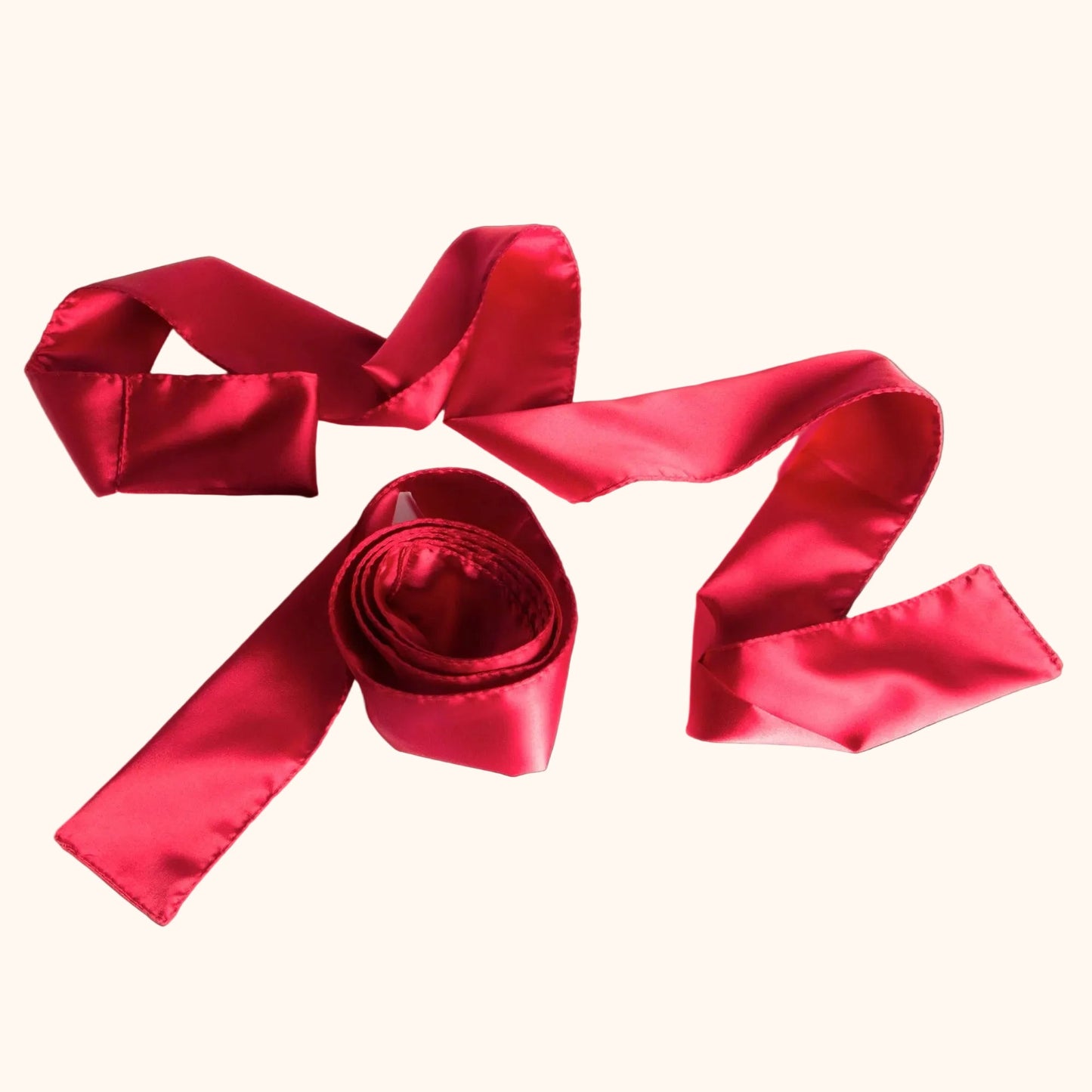 Two red Silky Tie-Ups by Liberator against a white background.