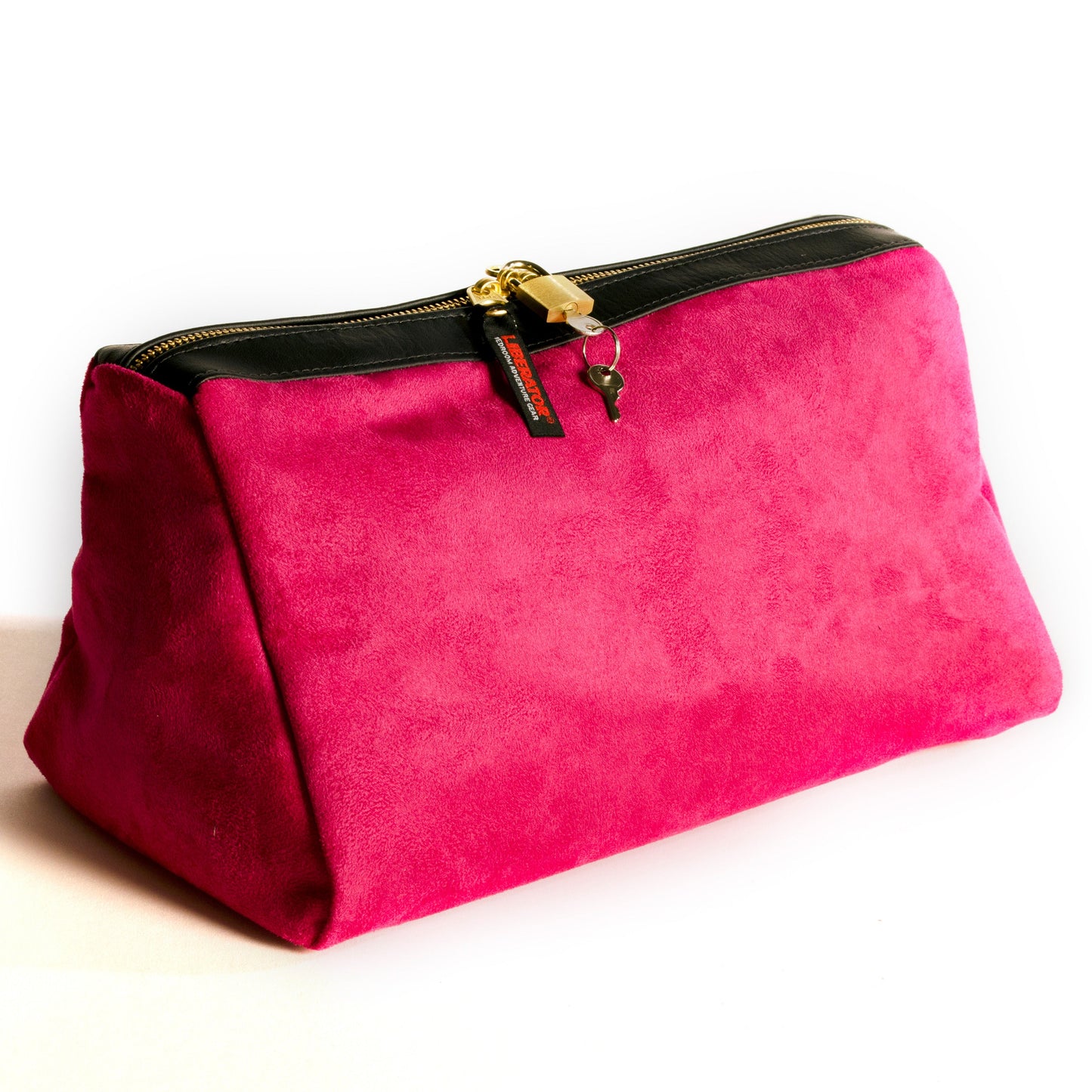 A fushia Tallulah Locking Toy Bag by Liberator with key and lock against a white background.
